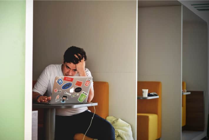 Frustrated man on a laptop browsing