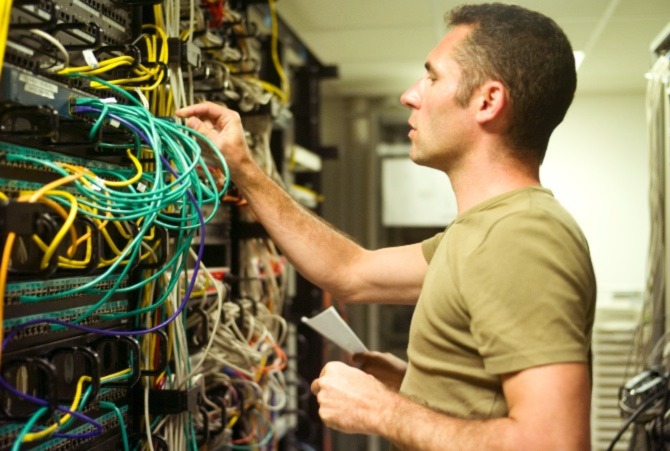 A man working in a server room